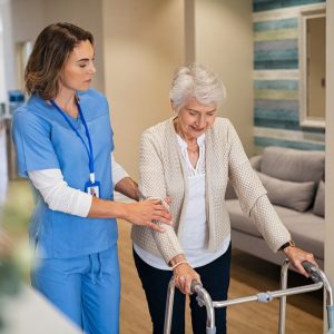 nurse-helping-senior-woman-to-walk-at-private-clin-2021-09-02-08-35-18-utc-1024x683